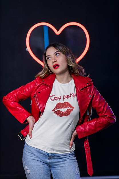 A young female in a red jacket and white organic cotton unisex t-shirt with bright red lips and the words 'Sexy pucker!' on the chest.