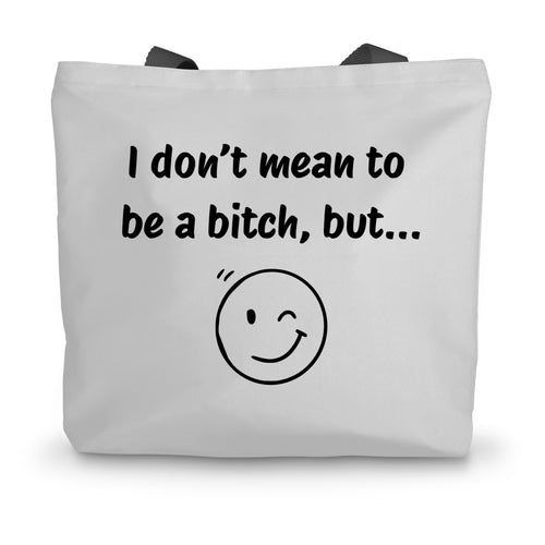 A white canvas tote bag with black handles and a winky face on the side beneath the words 'I don't mean to be a bitch, but...'