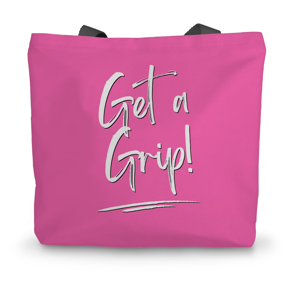 A hot pink canvas tote bag with black handles and the words Get a Grip! written on the side in white.