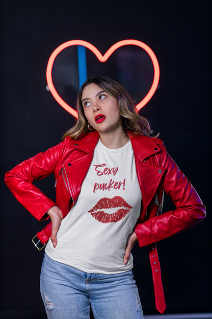 Young female wearing a white unisex crew neck t-shirt with a pair of lips and the words Sexy Pucker in bright red in the centre of the chest.
