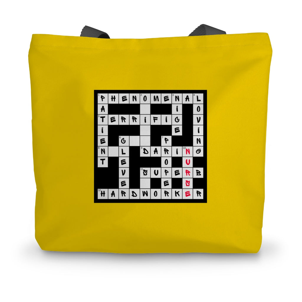 A bright yellow canvas tote bag with black handles and a crossword design on the side filled with positive words in black and the word nurse in red.