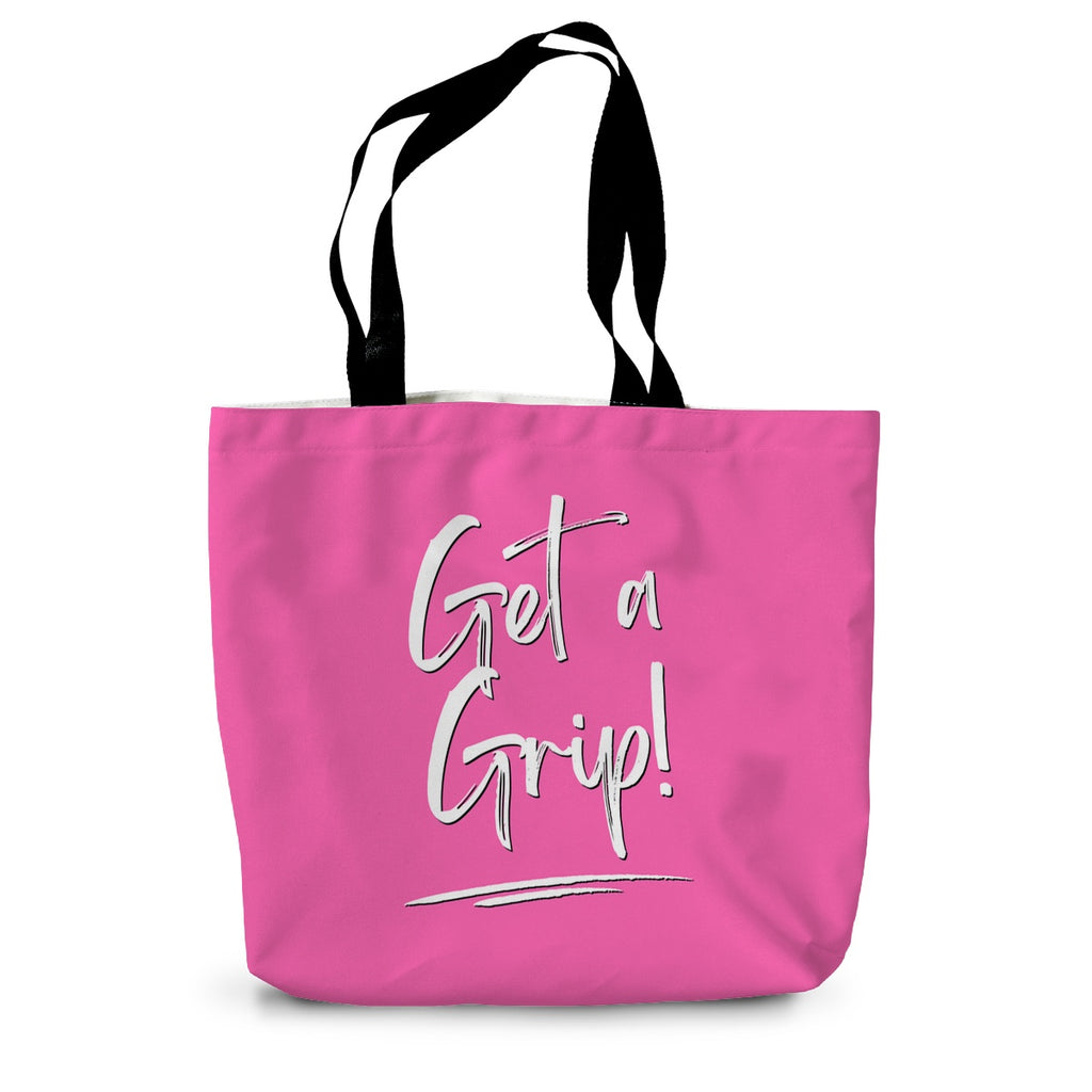 A hot pink canvas tote bag with long black handles and the words Get a Grip! written on the side in white.